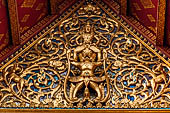 Chiang Mai - The Wat Phra Singh temple. The Viharn Luang (main prayer hall). Detail of the pediment showing a Garuda on a to bodies Naga, on its shoulders is Narai. 